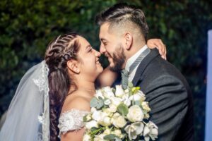 Joyful couple sharing a romantic moment at their wedding in México, embracing with love and happiness.